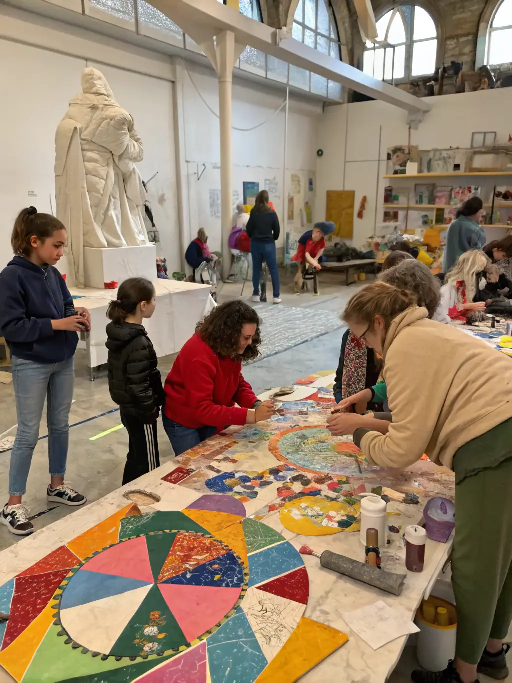 A group of artists and community members engaging in a workshop or networking event in a cultural space.
