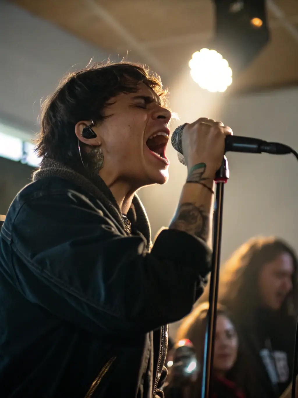 A vibrant image of a local artist performing on stage during a community event, with engaged audience members.